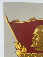 Close-up of a emblem with a profile of  Vladimir Lenin and a red flag on a gray background