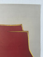 a sheet of paper with gold edges on a gray background
