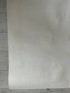 Sheet of beige paper on a wooden surface