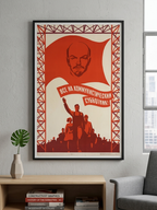 Framed poster with a stylized portrait of Vladimir Lenin and text on a wall in a modern living room.