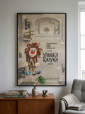 Framed movie poster of a clown on a wall in a living room.