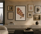 Wall art and decor in a living room with framed pictures and a vase.