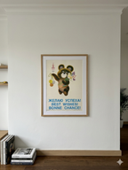 Framed artwork of Moscow Olympic bear with text on a white wall in a room.