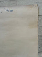 Sheet of paper with writing on a wooden surface