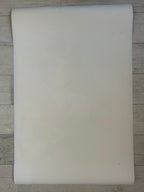 White rectangular sheet on a wooden surface