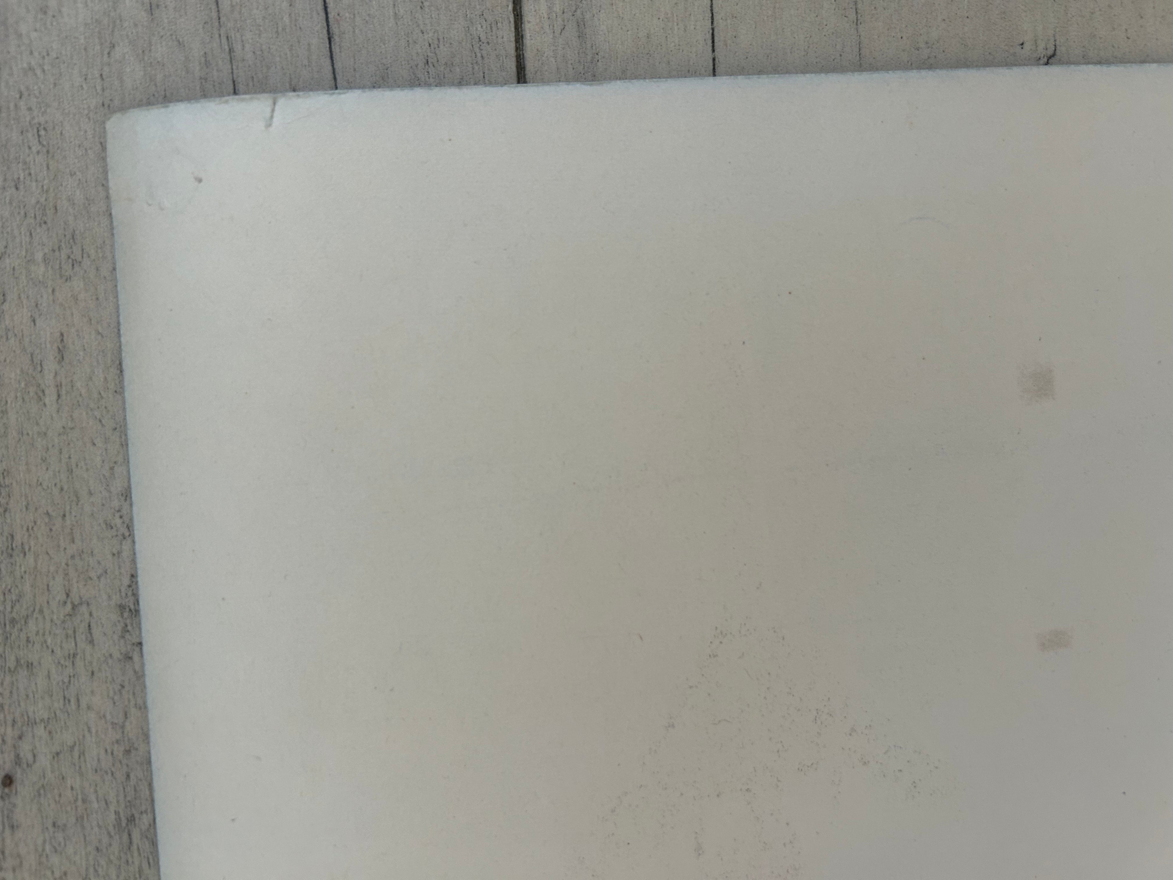 Close-up of a white cylindrical object on a textured surface