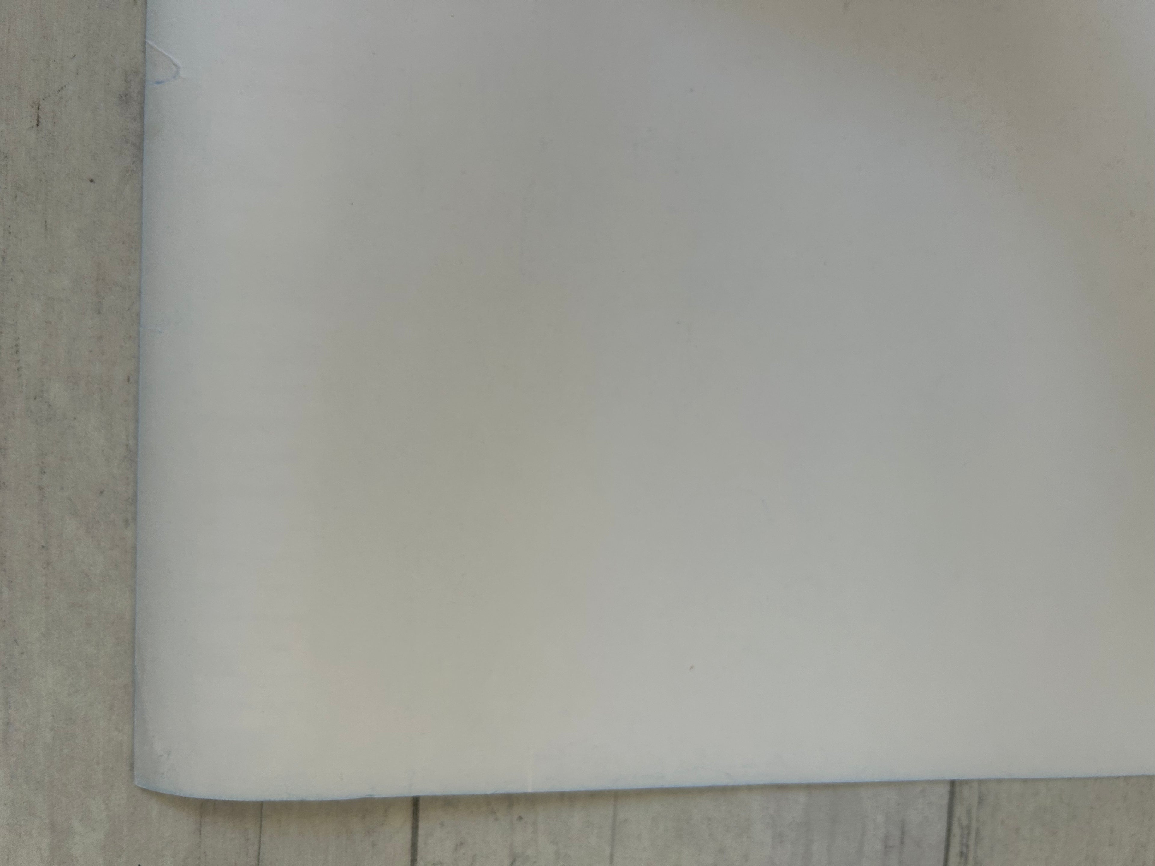 White sheet of paper on a textured surface