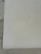 White sheet of paper on a wooden surface