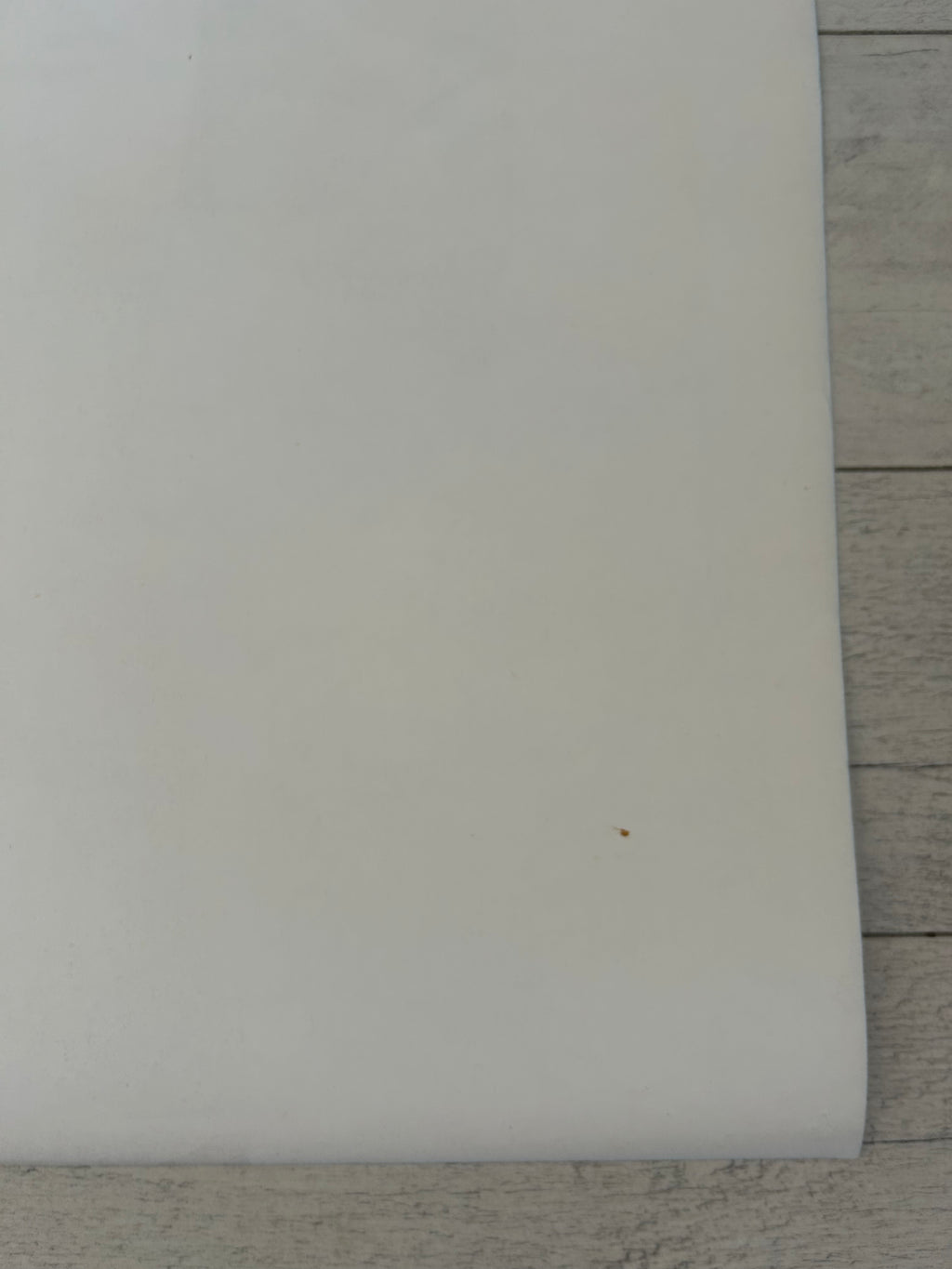 White rectangular object on a wooden surface