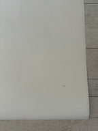 White rectangular object on a wooden surface