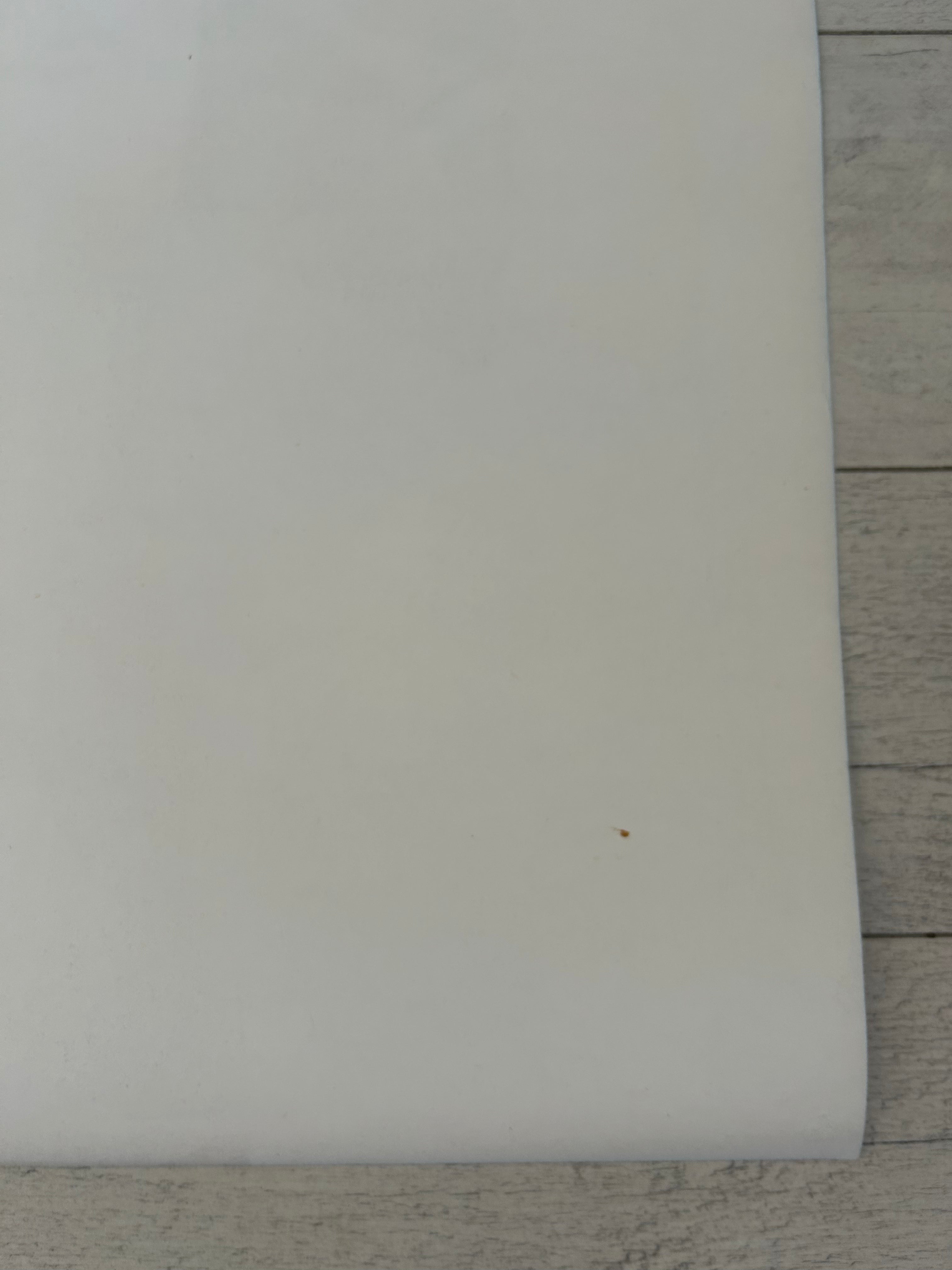 White rectangular object on a wooden surface