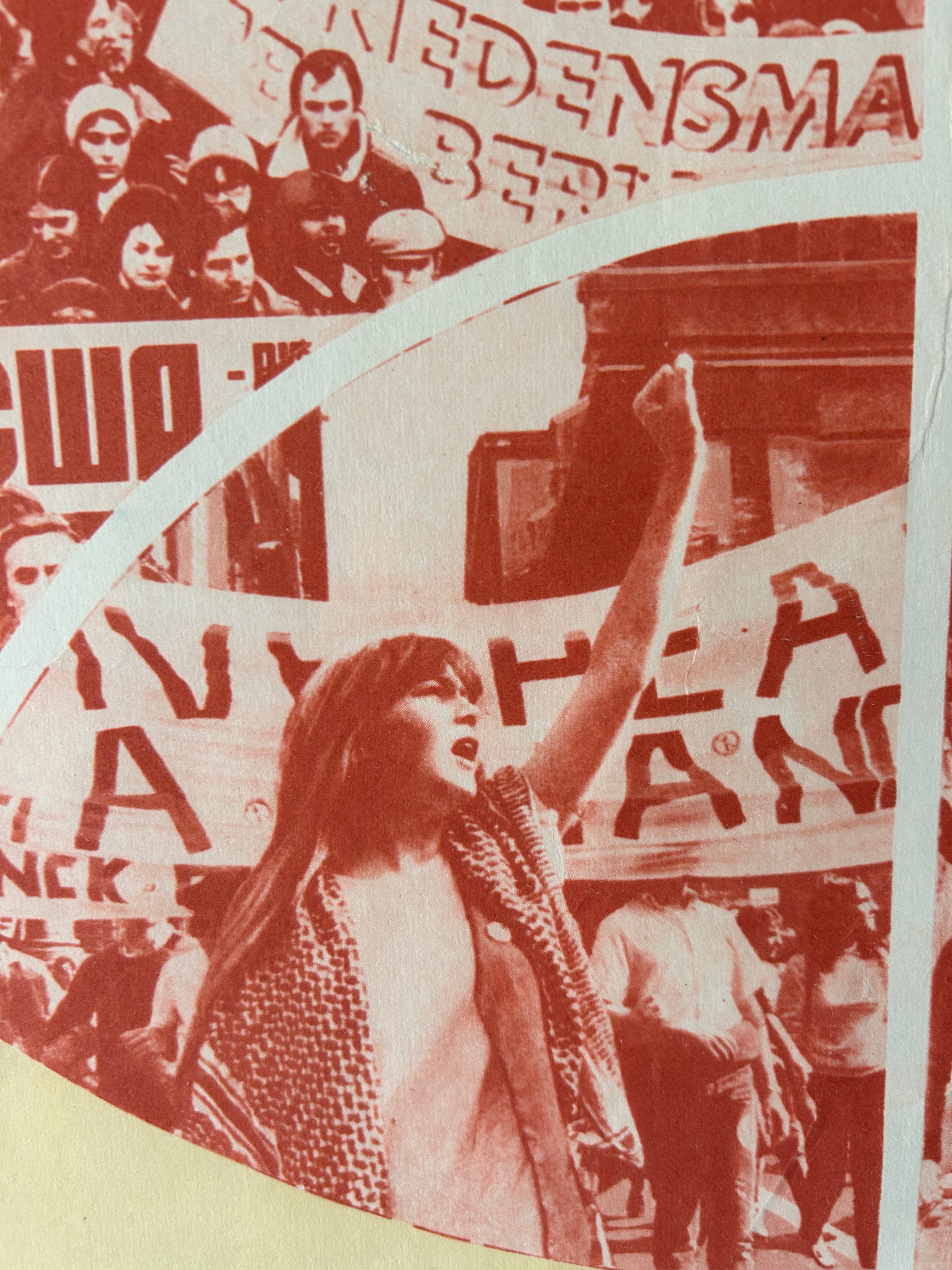 A close-up of a circular printed graphic or sticker featuring a sepia-toned protest scene with banners and text, including the word 'Beating' and other partially visible words.