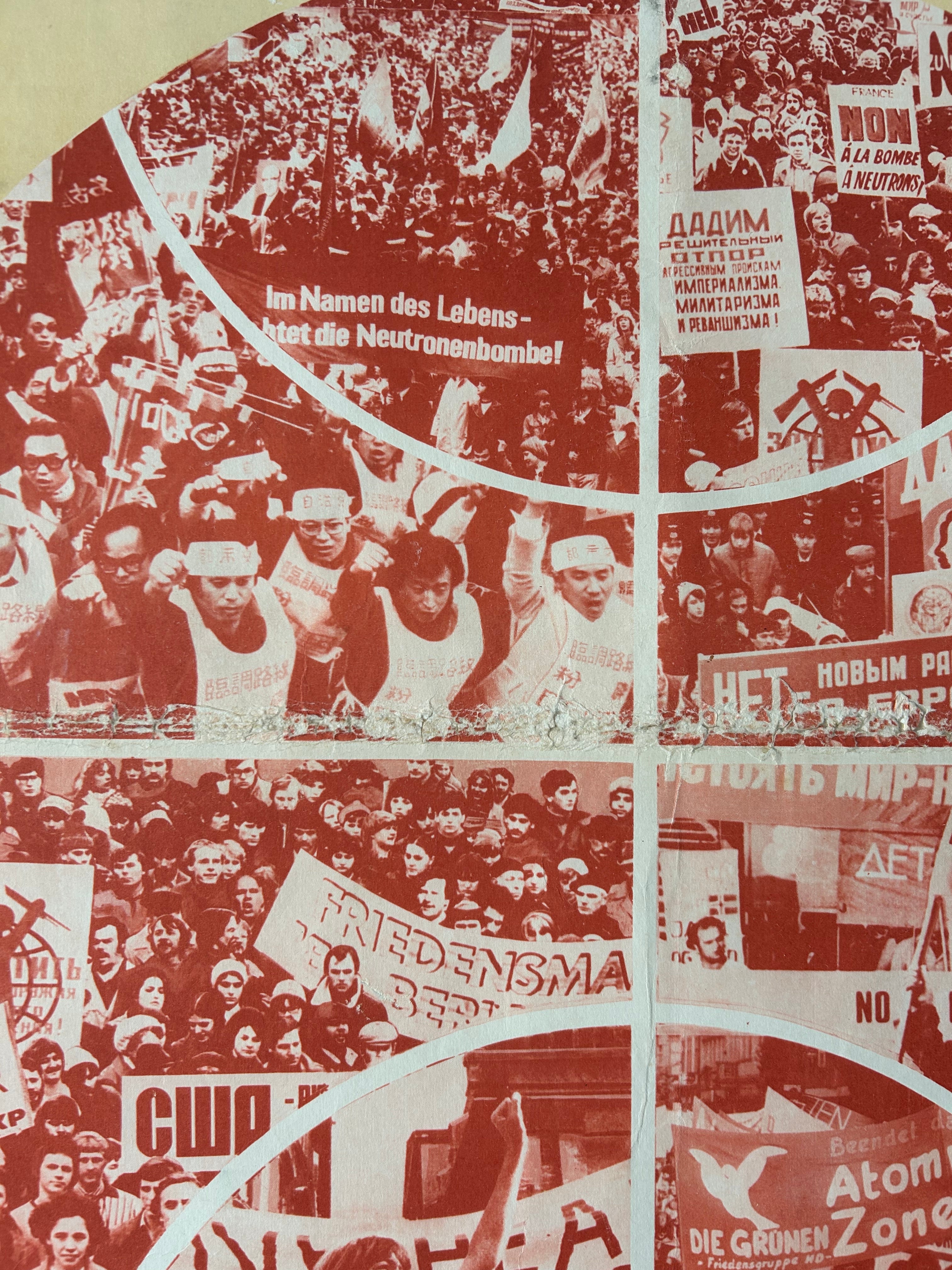 A close-up of a printed textile or wallpaper pattern featuring a collage of protest scenes in red and black-and-white tones, with curved white dividing lines and repeated banners and faces.