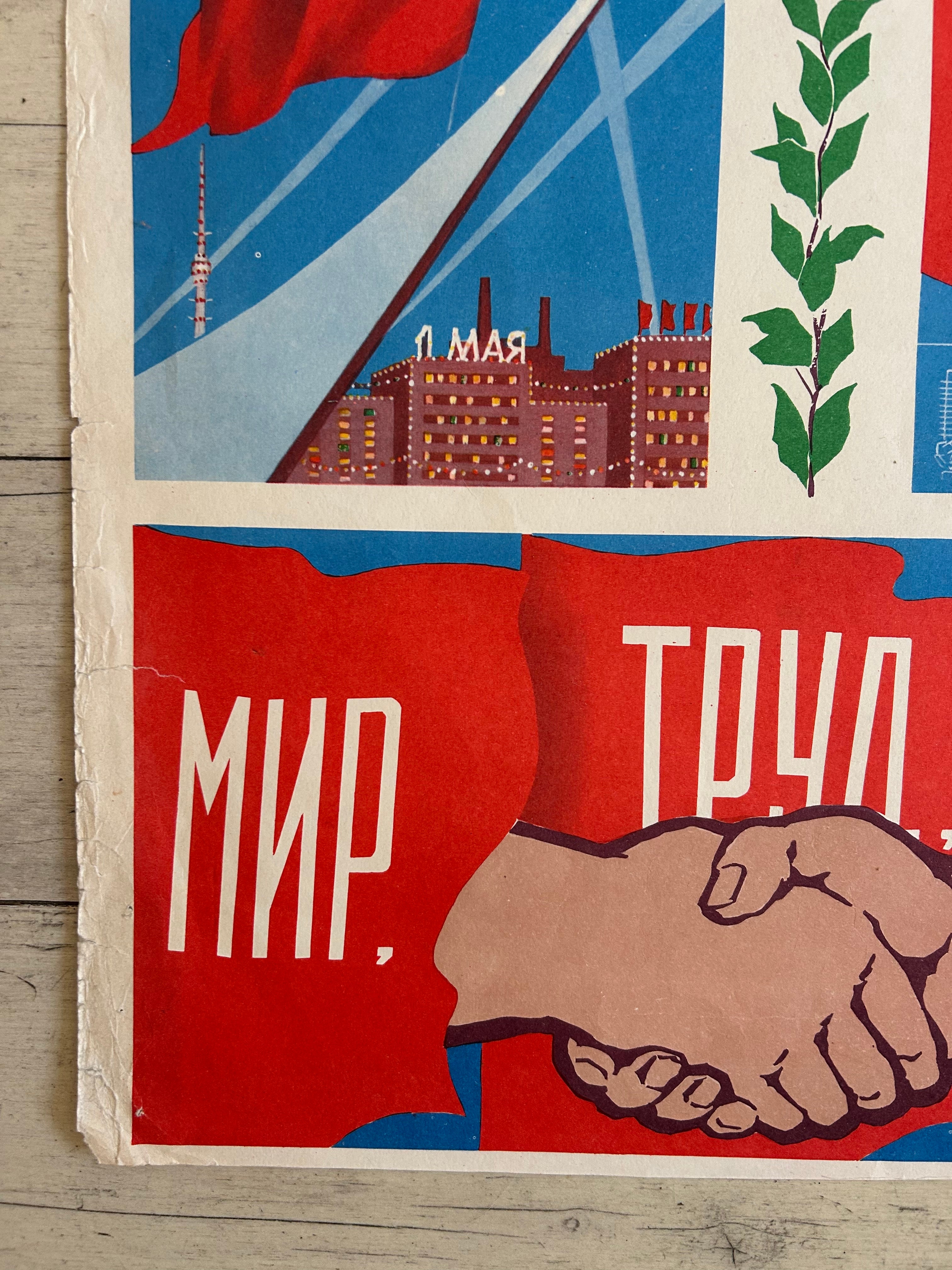 A close-up of a vintage Soviet propaganda poster featuring a handshake, a cityscape with the word 'Leningrad', a red flag, and Cyrillic text on a light wood background.