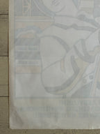 A vintage Japanese anime poster featuring a character in a space suit, displayed on a light-colored wooden surface. The bottom of the poster has Japanese text and a barcode.