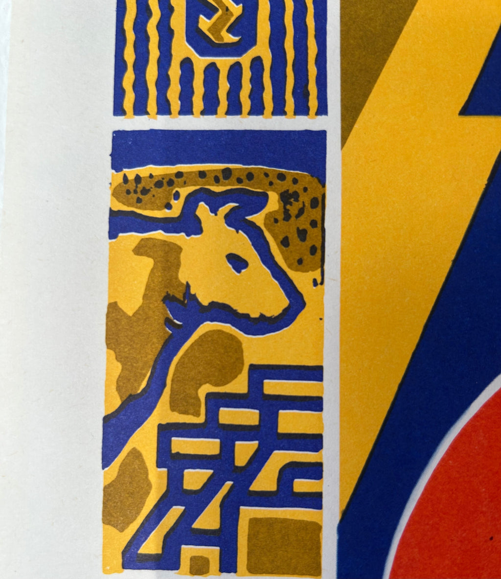 A close-up of a graphic art print featuring a stylized cow in yellow and blue blocks, alongside bold yellow, blue, and red geometric shapes on a white background.