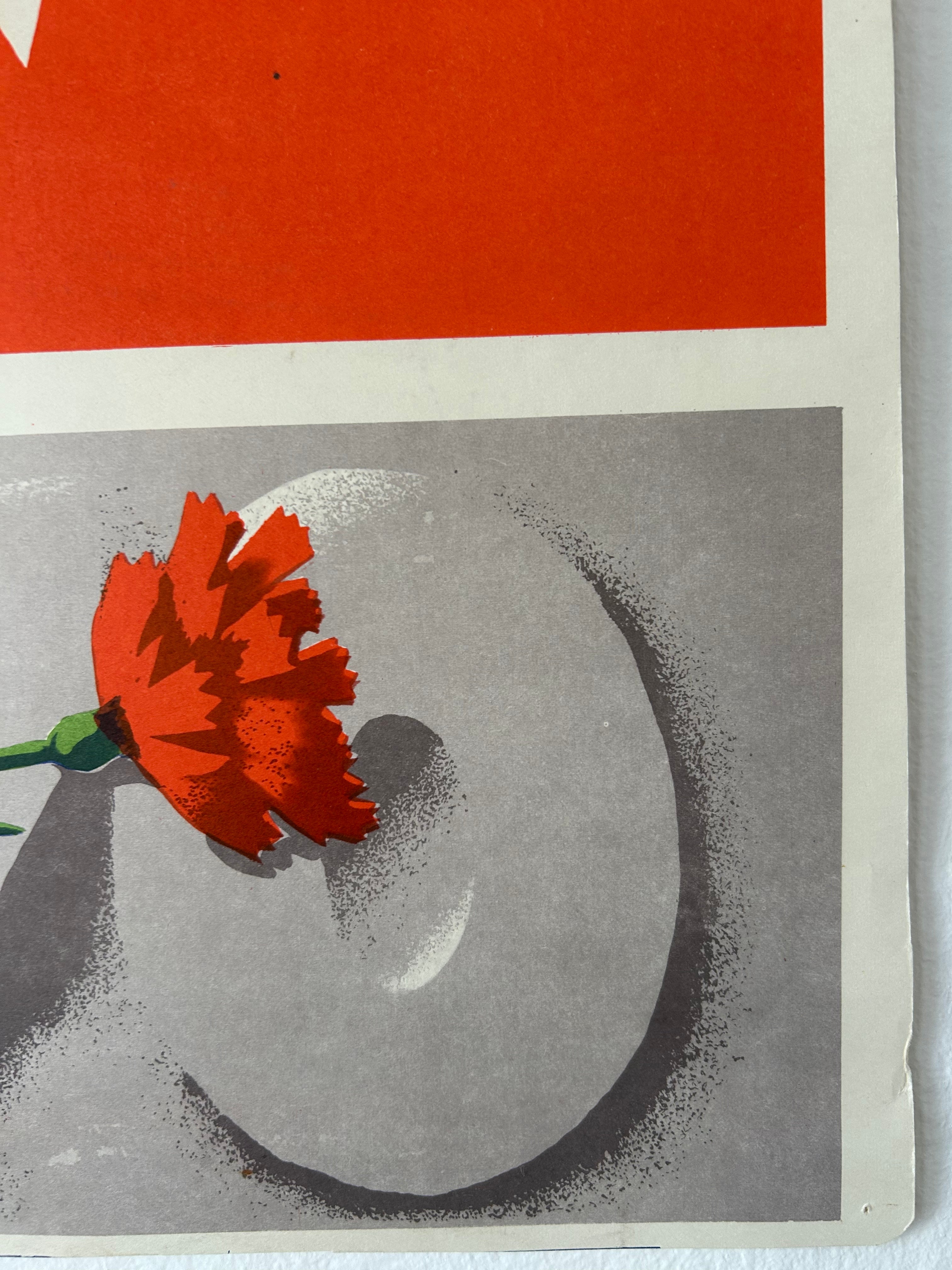 A close-up of a graphic art print featuring a red flower resting on a gray circular form, with a bold red-orange block at the top and a white border around the artwork.