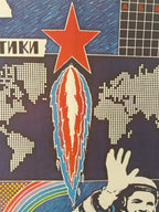 A close-up of a graphic print or textile featuring a red star, a pixelated world map, a rocket trail, and a stylized astronaut waving, with partial Cyrillic text visible.